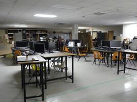 Computer classroom with computers on table tops.