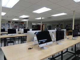 Tables with wide-screen Macintosh computers