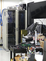 Communications cabinet in background; equipment cart in foreground.