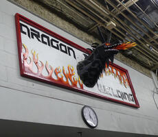 3-D welded metal dragon attached to sign: Dragon Welding