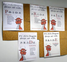 Posters with “P.C.H.S. Ddragons always act with:” and acronyms for P R I D E (Purpose, Respect, Impulse Control, Dedication, and Excellence)