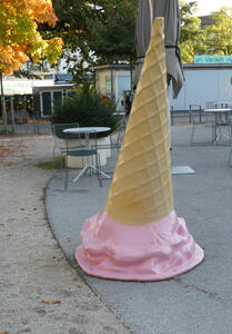 Large (1,5 m) ice cream cone upside down, pink ice cream is “melting” on the ground.
