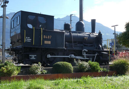 Old black steam locomotive in front of Buchs train station