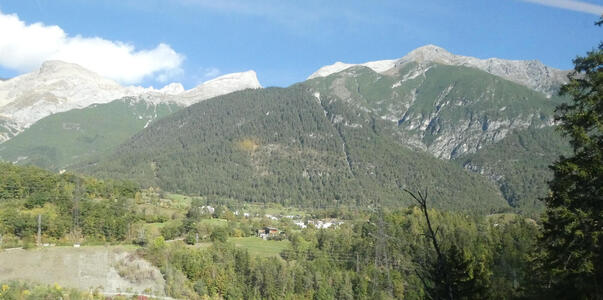 Forested mountains. Top area of mountain has no trees on it.