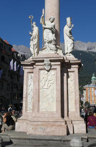 Base of Pestsäule with three religious figures, one carrying a shepherd’s staff