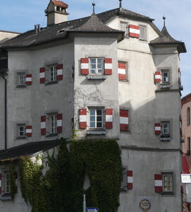 Building with red/white/red striped window shutters