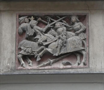 Relief carving of knights fighting with swords