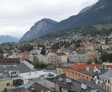Houses in foreground, mountain in background.