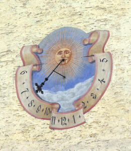 Sundial with drawing of sun in the middle
