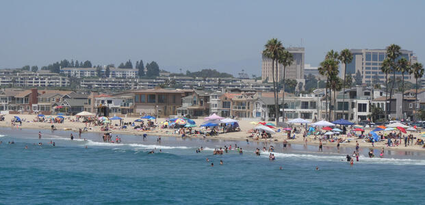 View from pier of beach and buildings behind it