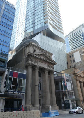 old building between new buildings