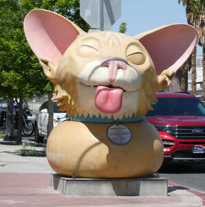 Ten-foot head of cat with tongue sticking out.