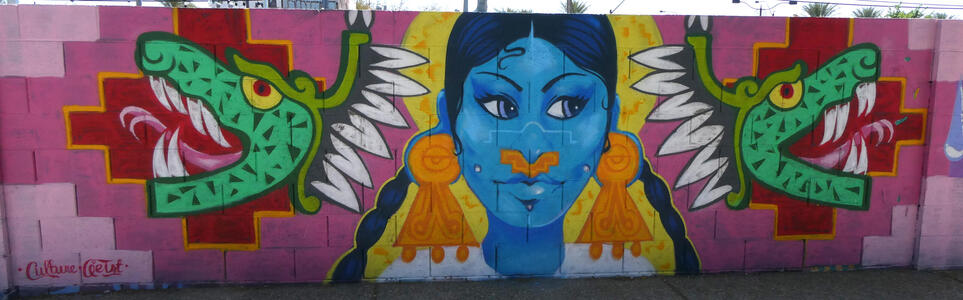 Green aztec snakes flanking woman with blue face and gold earrings