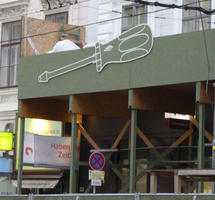 Construction site scaffolding with picture of large screwdriver