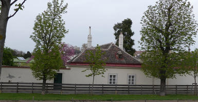 Building with brown shingles and red eaves