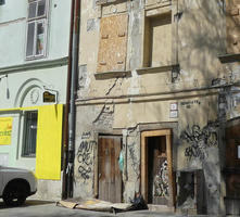 Crumbling building next to one in good condition