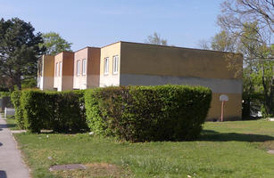 Rectangular blocky apartment buildings in pastel yellow and orange